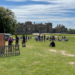 Holkham Hall on a busy day from across the cricket pitch