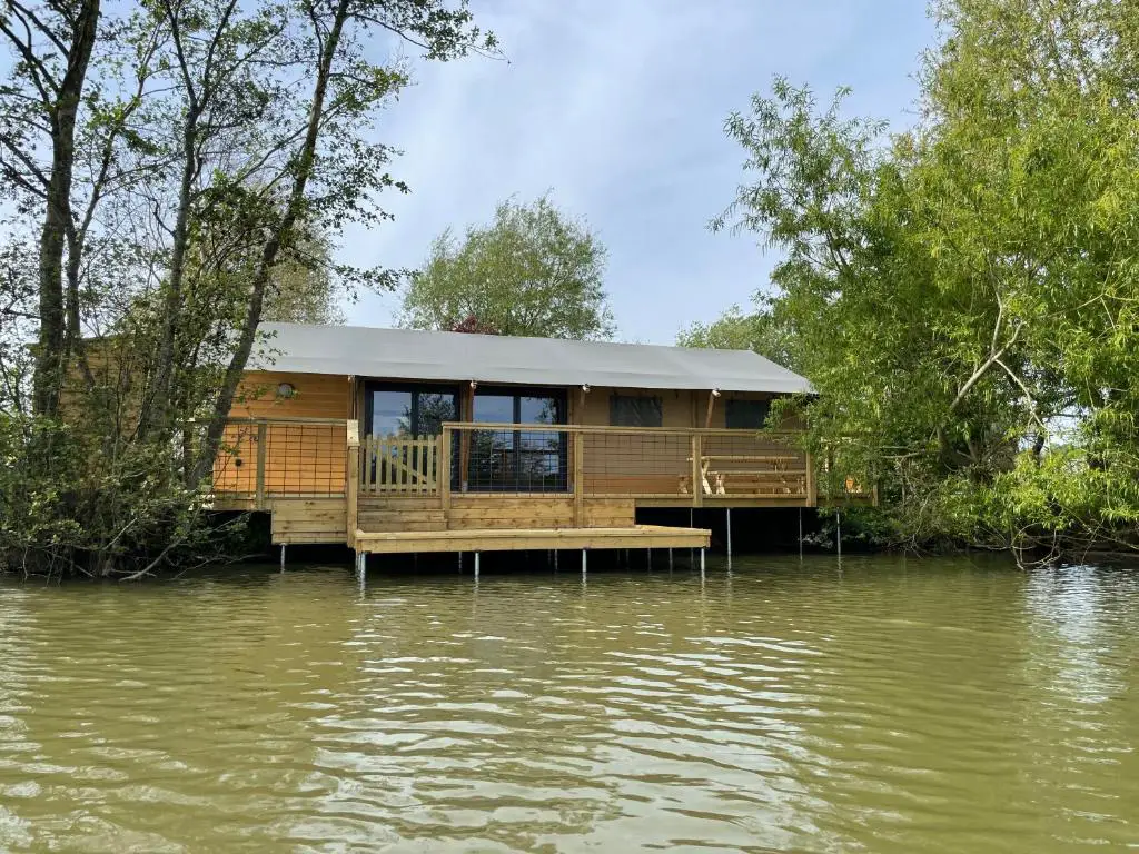 Sumners Pond Lodges set on the bank with a private fishing peg over the lake