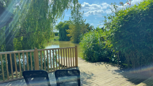 Mill Farm Lodges - A decked private fishing peg in front of the lodge overlooking a well establised lake