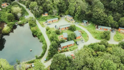 An aerial shot of Herons lake fishing lodges. There are numerous fishing lodges around a small lake