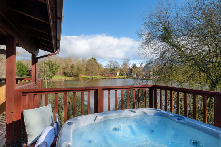 Otter Falls hot tub on decking overlooking the fishing lake
