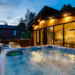 A lodge at Finlake holiday park with a bubbling hot tub in front