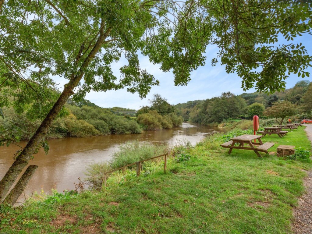 Bank of the River Severn with steps down to a peg and some picnic benches