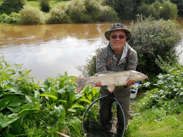 Barbel caught at barbel lodge on the bank of the Severn with the river in the background
