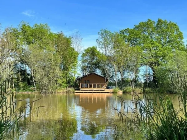 Elbridge far fishing lodge with decking over peacocks lake