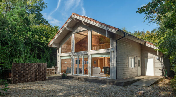 Mill meadow luxury lodges - a large 2 story lodge with glazed windows