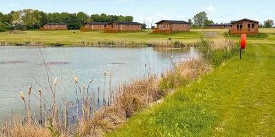 A fishing lake with 5 lodges around the bank setback from the lake