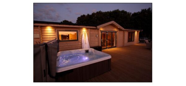 Lodge and decking a night with downlights and illuminted hot tub
