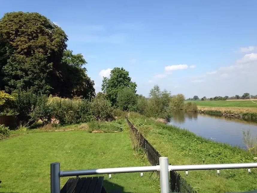 Riverside garden and railings at Bank Cottage, Hanley Castle, looking over the River Severn