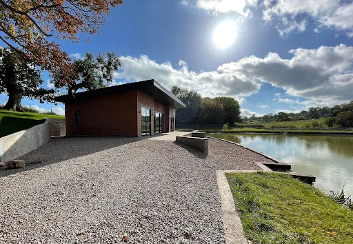 Timber clad lakeside lodge beside the lake at Blackthorn Fisheries Pines Lake Lodges, Shropshire