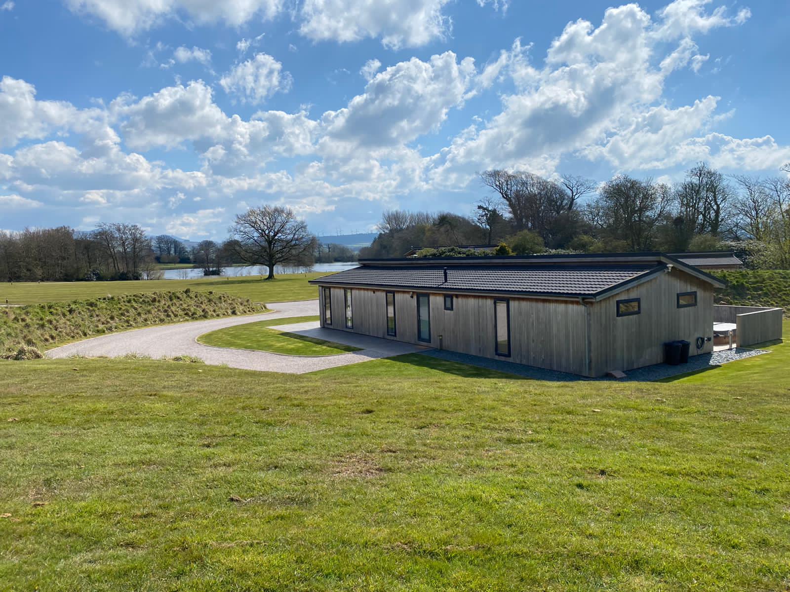 Timber lodge with hot tub and lake views at Brayton Park, Aspatria, Cumbria