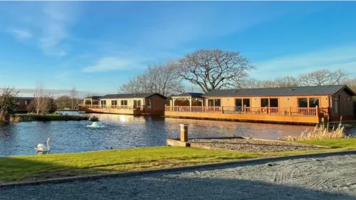 Lakeside lodges with decking overlooking the water at Caistor Lakes, Lincolnshire