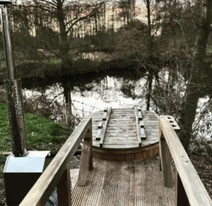 Wood fired hot tub on lakeside decking at Colehurst Lake Lodges, Shropshire