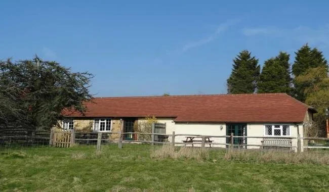 Single storey holiday cottages at Lewes in Sussex with picnic bench and paddock
