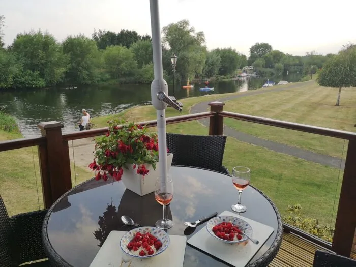 Lodge decking table set with desserts and drinks overlooking the River Avon
