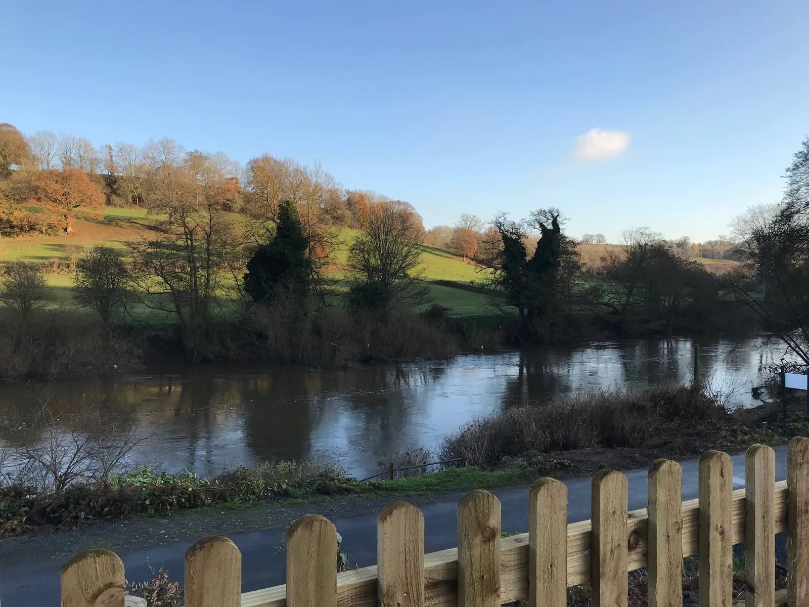 View across the River Severn to wooded hillside and fields from River Steam Holidays, Highley